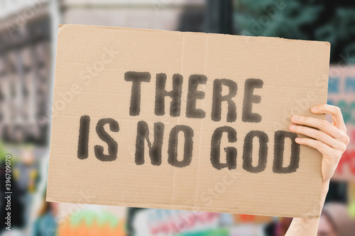 Photography The phrase  There is no god  on a banner in men's hand with blurred background