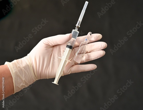 Syringe and new vaccine in the hand of a doctor. Covid-19