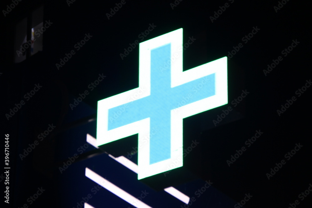 Obraz premium Glowing pixel cross of LED lamps on black background.