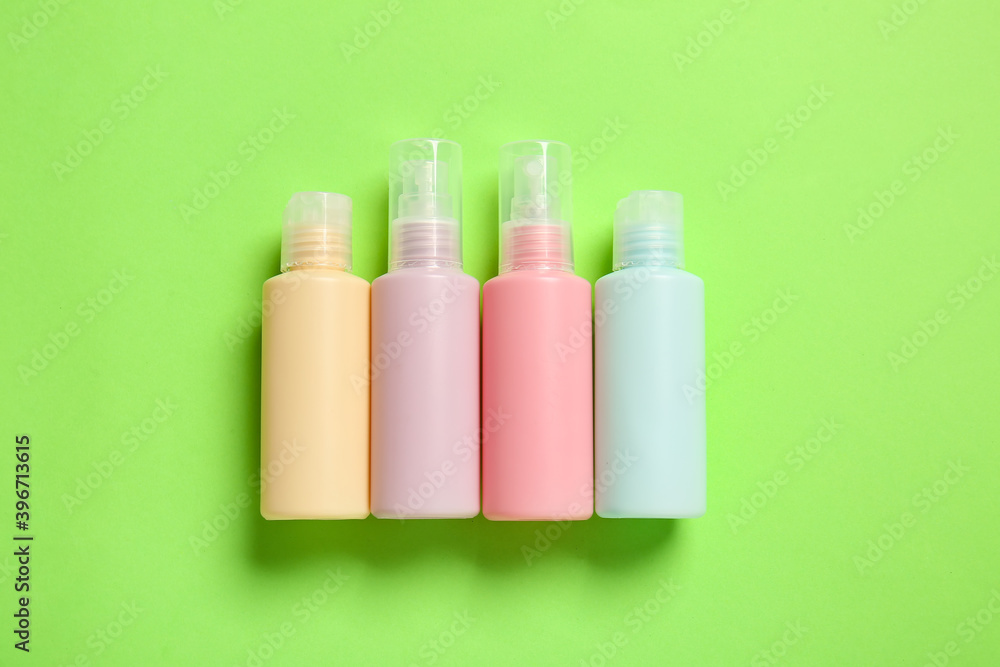 Set of travel bottles with body care cosmetics on color background Set of travel bottles with body care cosmetics on color background