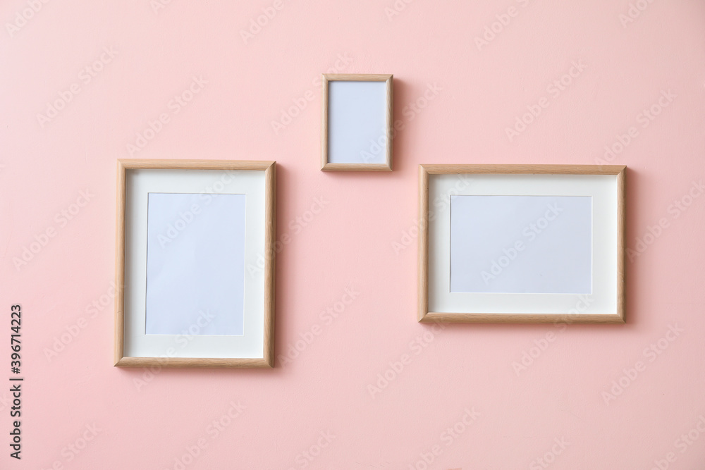 Blank photo frames on color wall Blank photo frames on color wall
