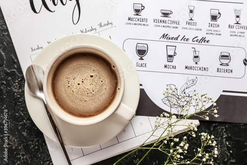 Cup of hot coffee and menu ...