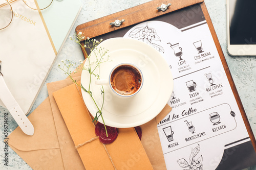 Cup of hot coffee and envel...