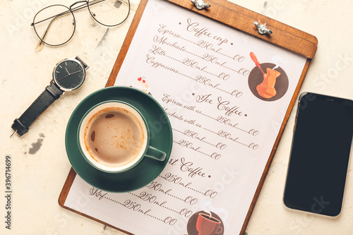 Cup of hot coffee and mobil...