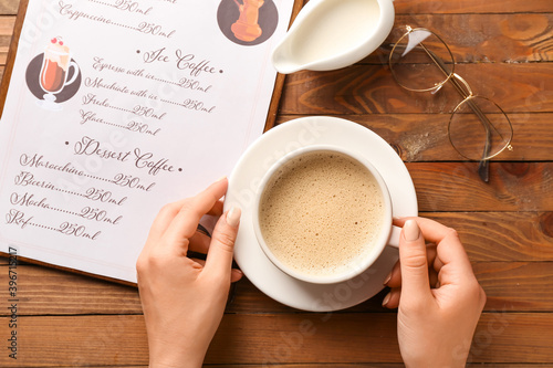 Female hands and cup of hot...