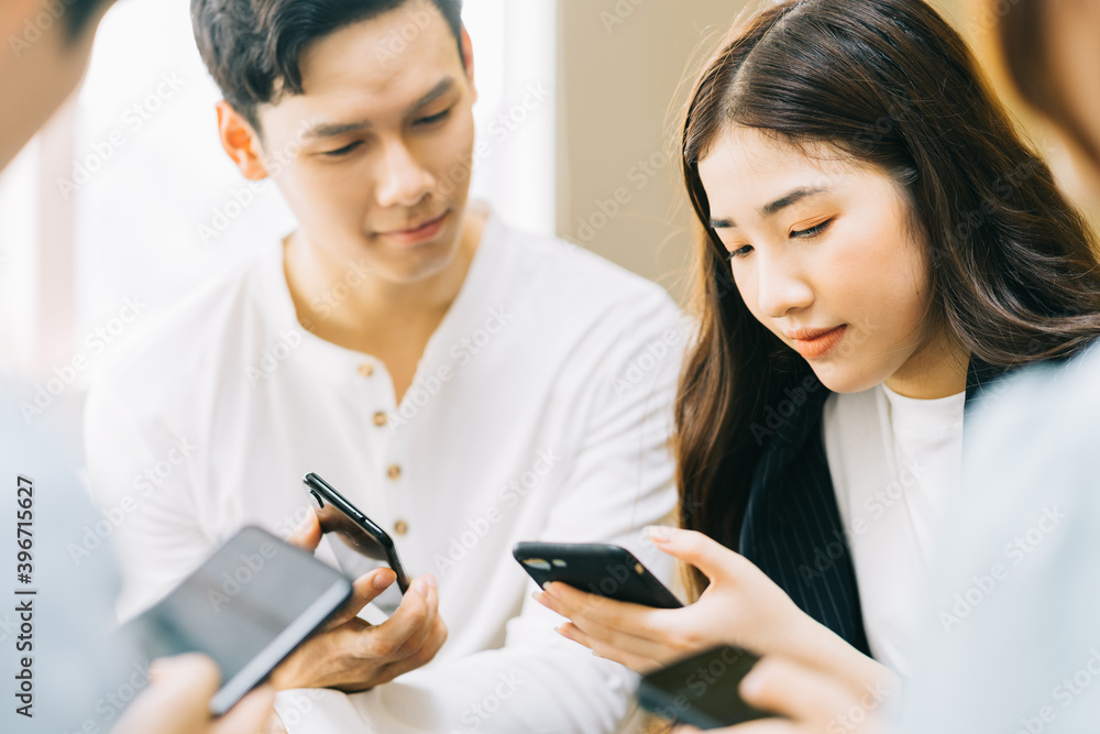 Young Asians are using their phones to connect with each other through social networking platforms Young Asians are using their phones to connect with each other through social networking platforms