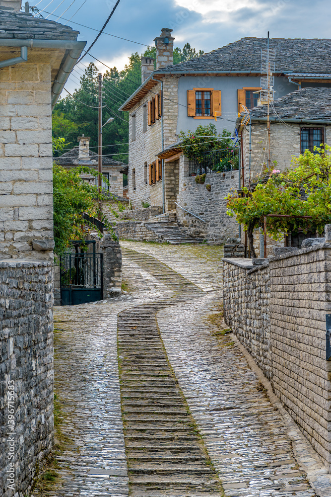 Traditional architecture with  narrow  street and stone buildings a in Vitsa village  central Zagori Greece