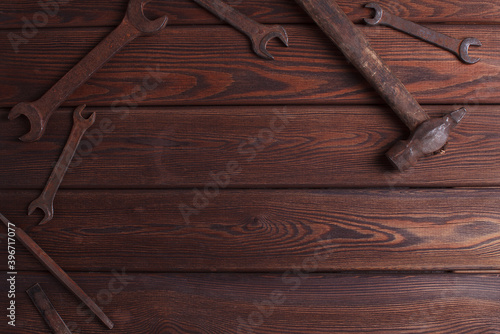 Old Rusty Tools on the Grunge Wooden Background