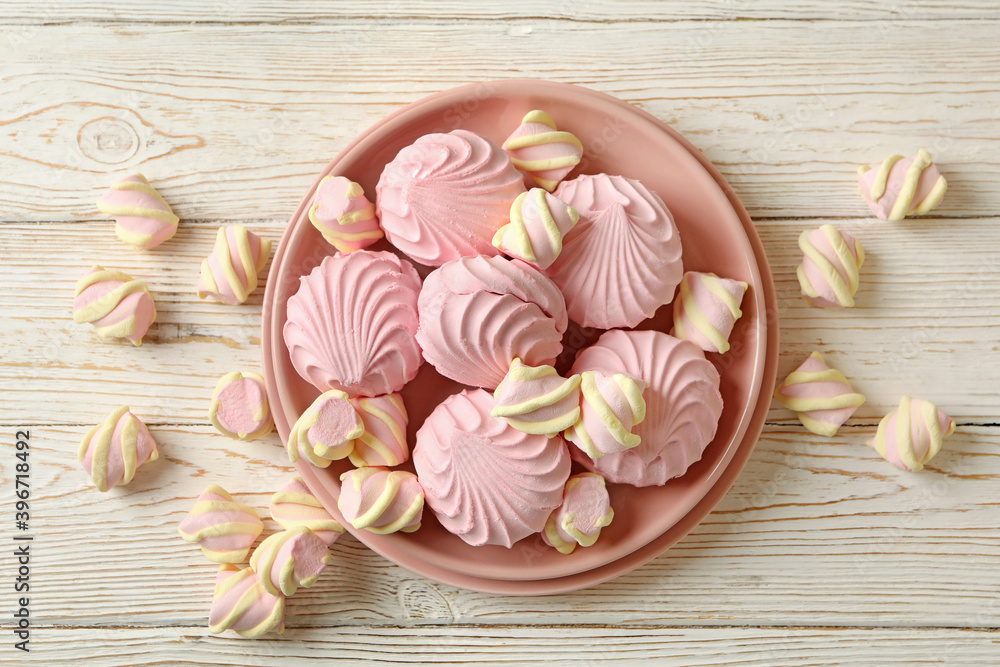 Plate with sweet marshmallow on wooden background Plate with sweet marshmallow on wooden background