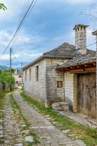 Traditional architecture with narrow street and stone buildings a in Vitsa village central Zagori Greece