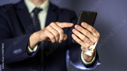 A business man typing on cell phone. Closeup.