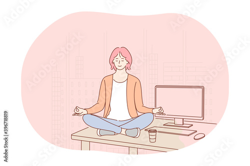 Yoga, meditation, healthy active lifestyle concept. Young smiling woman worker sitting in lotus position on table in office, practicing yoga, relaxing and meditating on workplace with eyes closed