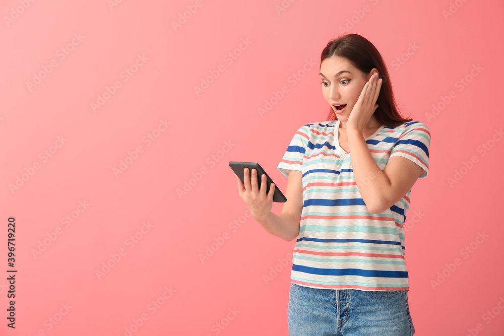 Surprised young woman with e-reader on color background Surprised young woman with e-reader on color background