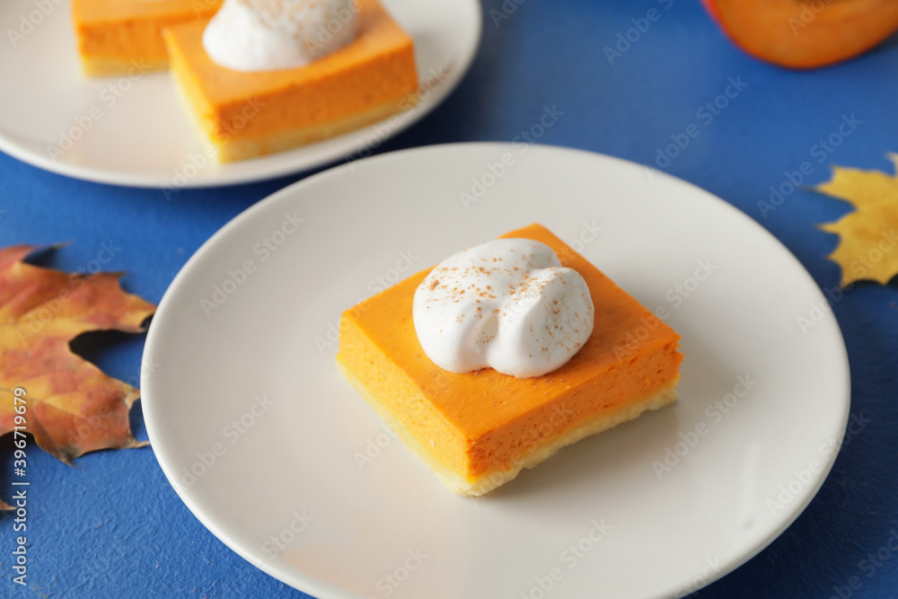 Plate with piece of tasty pumpkin pie on table Plate with piece of tasty pumpkin pie on table
