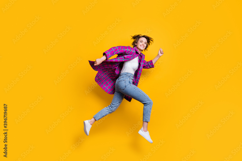 Full size profile side photo of brown bob curly haired woman run fast jump up sale isolated on yellow color background Full size profile side photo of brown bob curly haired woman run fast jump up sale isolated on yellow color background