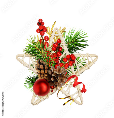 Dry rattan star with Christmas decorations, red berries and green pine twigs