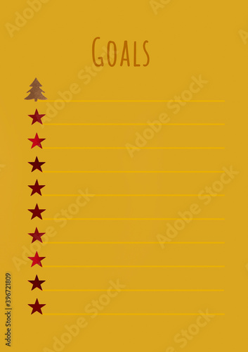 Goals. Sparkles stars, a sheet of yellow Notepad, top view photo