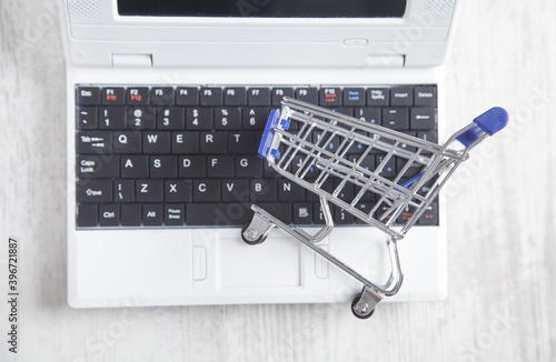 Shopping cart on laptop keyboard. Online Shopping