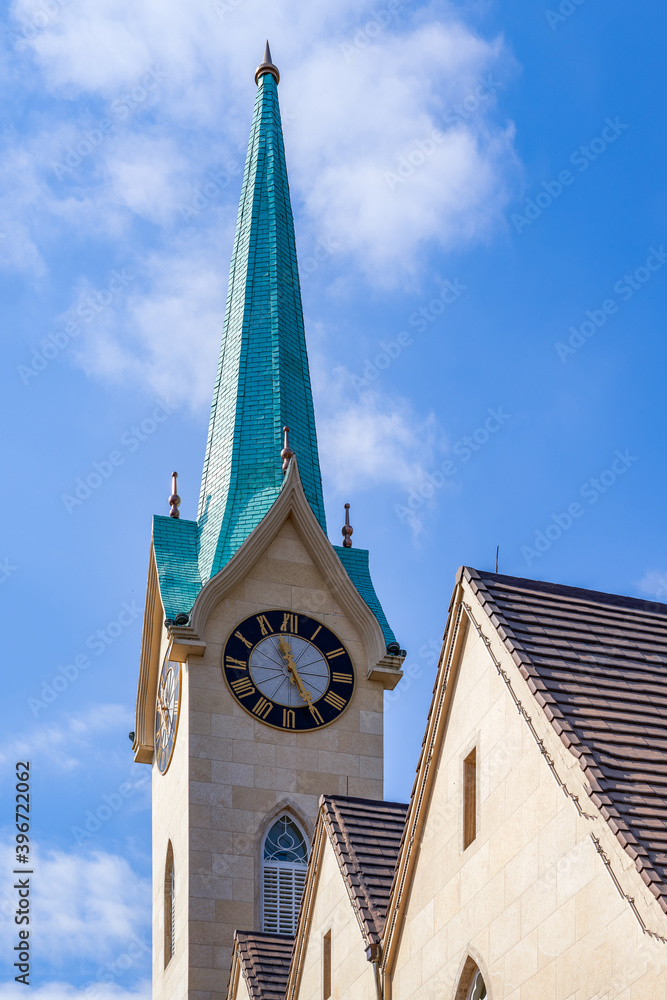 Full view and partial close-up of European-style steeple church, Gothic architecture