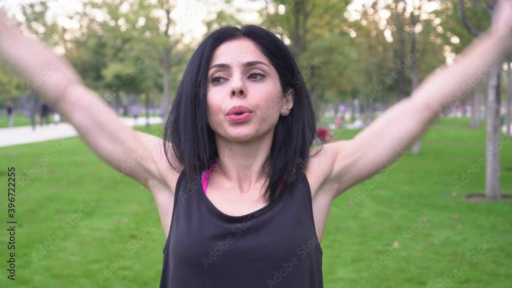 Attractive sportive brunette woman goes in for sports in the park Attractive sportive brunette woman goes in for sports in the park