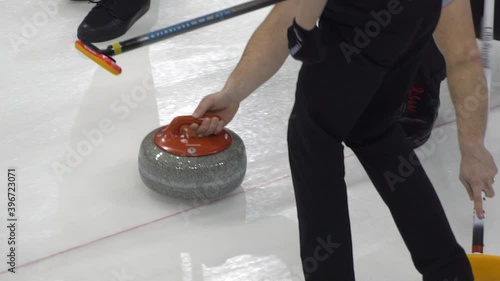 Curling. Winter Olympic sport. Curling stone. Winter sport in which players slide stones on a sheet of ice to special target.