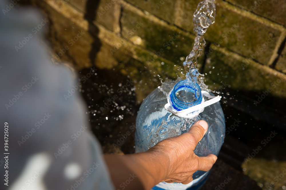 Collecting natural spring water with day zero water crisis with plastic