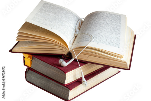 Old books with headphones on a white background Audiobooks