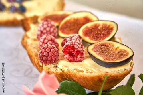 Sandwich with croissant and figs. A healthy snack with berries. Fresh bakery. High quality photo
