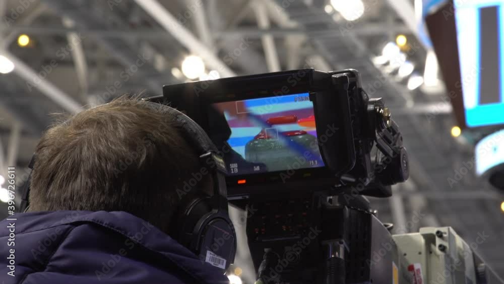 A special video camera for broadcasting a sports match. Video broadcast of a sporting event. Curling.  Olympic sport.  Curling stone.