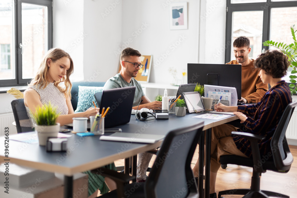 business, people and corporate concept - team of startuppers or ui designers working at office business, people and corporate concept - team of startuppers or ui designers working at office