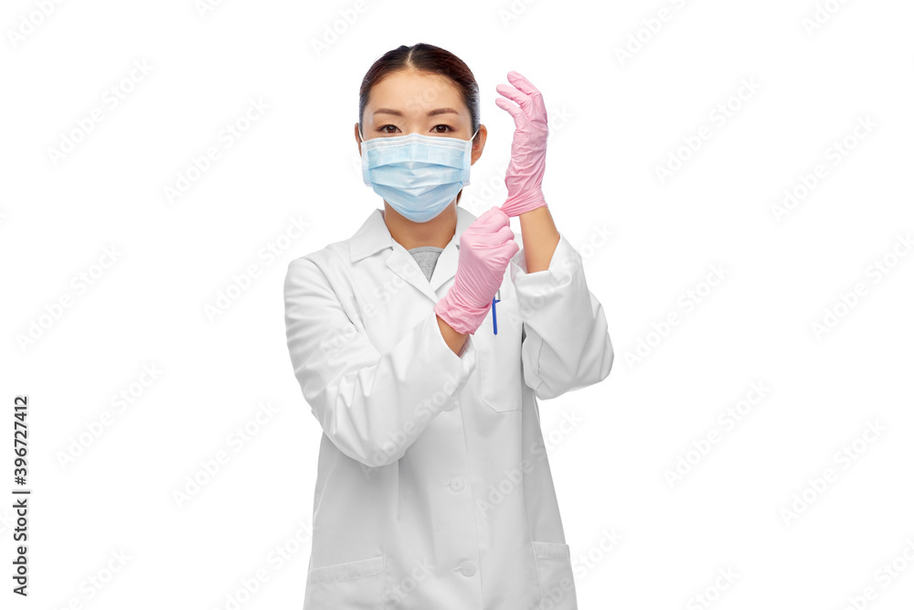 health, medicine and pandemic concept - young asian female doctor or scientist wearing face protective medical mask and gloves for protection from virus disease health, medicine and pandemic concept - young asian female doctor or scientist wearing face protective medical mask and gloves for protection from virus disease