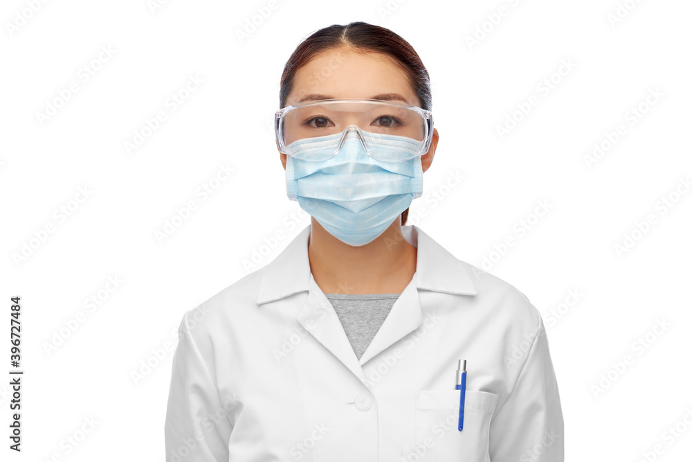 health, medicine and pandemic concept - young asian female doctor or scientist wearing goggles and face protective medical mask for protection from virus disease health, medicine and pandemic concept - young asian female doctor or scientist wearing goggles and face protective medical mask for protection from virus disease