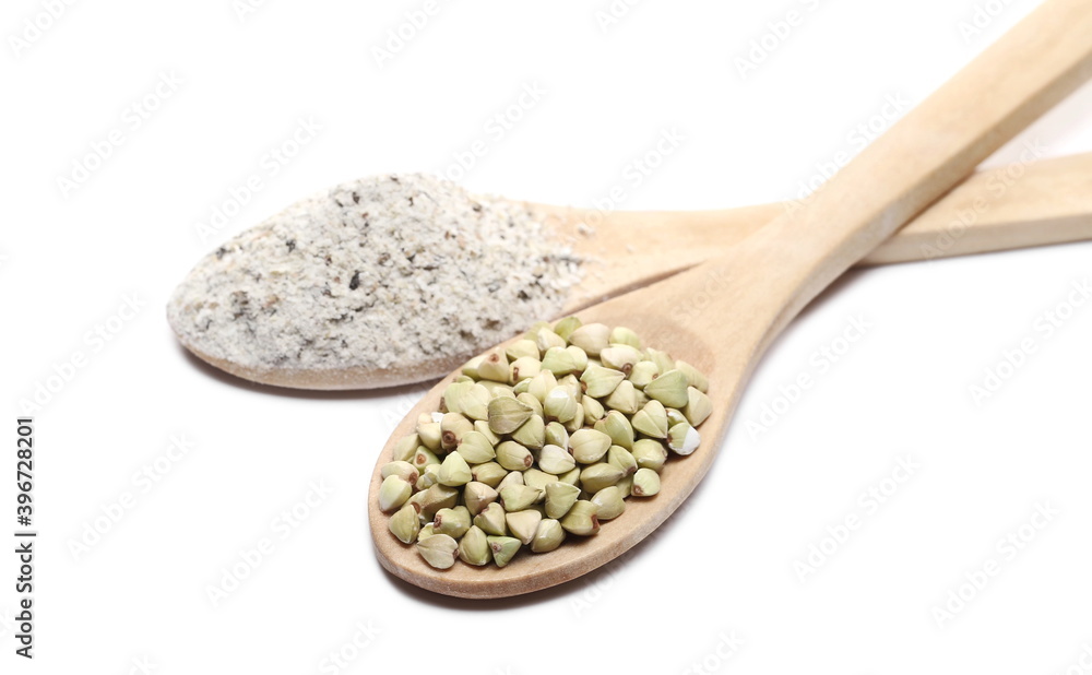 Buckwheat seeds and flour pile with wooden spoon isolated on white background Buckwheat seeds and flour pile with wooden spoon isolated on white background