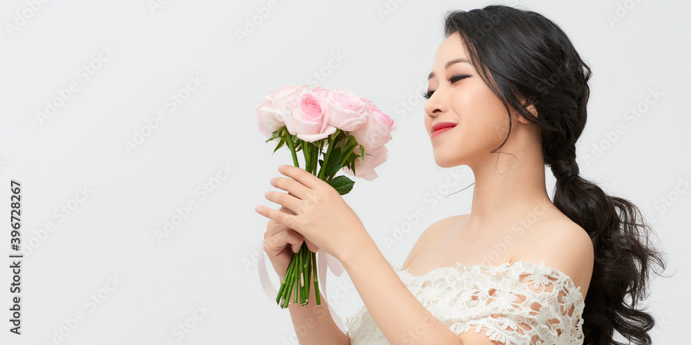 Woman with Spring Flower bouquet. Happy surprised model woman smelling flowers. Mother's Day. Springtime