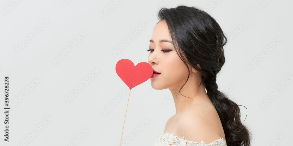 Portrait of pretty girl holding red paper heart on stick Portrait of pretty girl holding red paper heart on stick