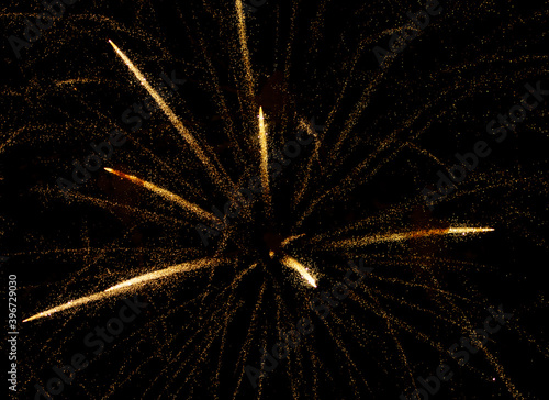 fireworks with yellow sparks on black background