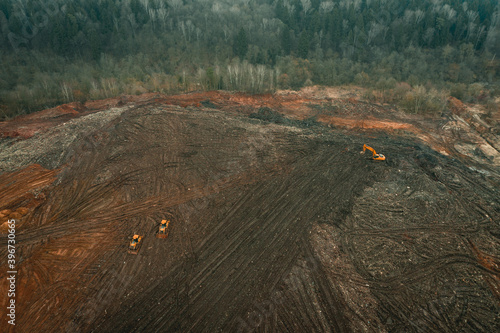 Reclamation of solid waste landfill by heavy machinery