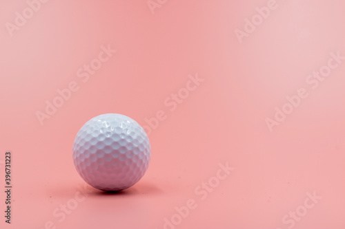 Golf ball is on pink background