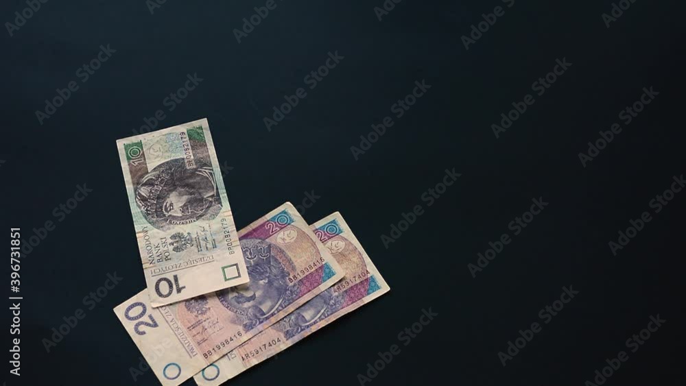 The Ukrainian hryvnia in the amount of a thousand hryvnias falls, flies on a black background, the Ukrainian state currency, a lot of bills.2021 The Ukrainian hryvnia in the amount of a thousand hryvnias falls, flies on a black background, the Ukrainian state currency, a lot of bills.2021