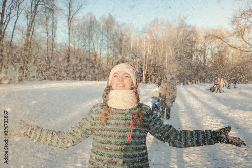 Happy woman have fun, play and throw snow up outdoors in winter nature. Snow fly.