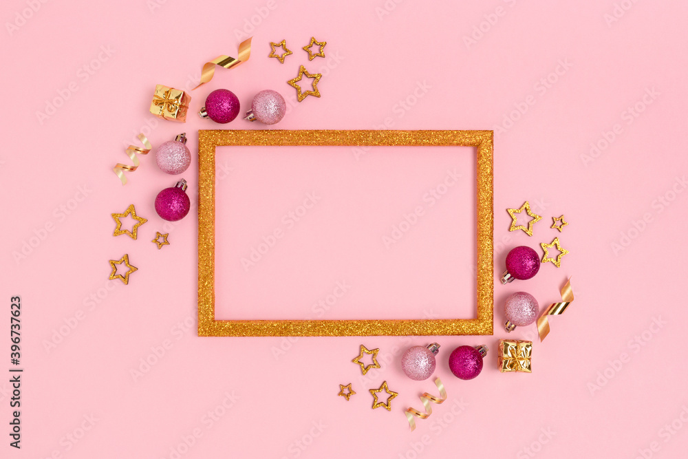 Glittering frame made of pink Christmas baubles and gold confetti. Festive composition with place for your design. Glittering frame made of pink Christmas baubles and gold confetti. Festive composition with place for your design.