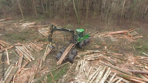 Aerial side rotating drone view of cutted wood being gathered. photo