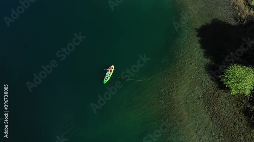 Aerial top down of two experienced dry fly fishers in a kayak close to shore in Lake Steffen, Patagonia Argentina. photo