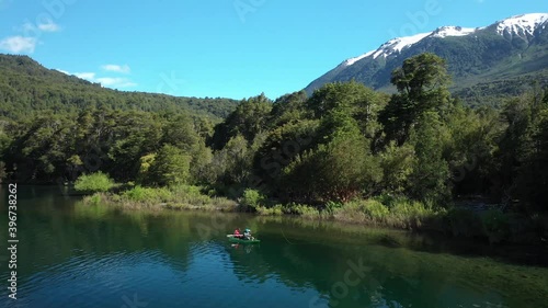 Panning left of two men dry fly fishing in a kayak near the Shore in Lake Steffen, mountains in background, Patagonia Argentina. photo