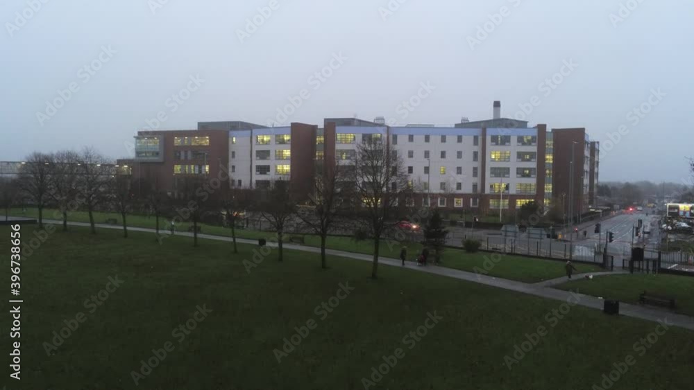 Aerial view British NHS hospital on misty wet damp morning park descent Aerial view British NHS hospital on misty wet damp morning park descent