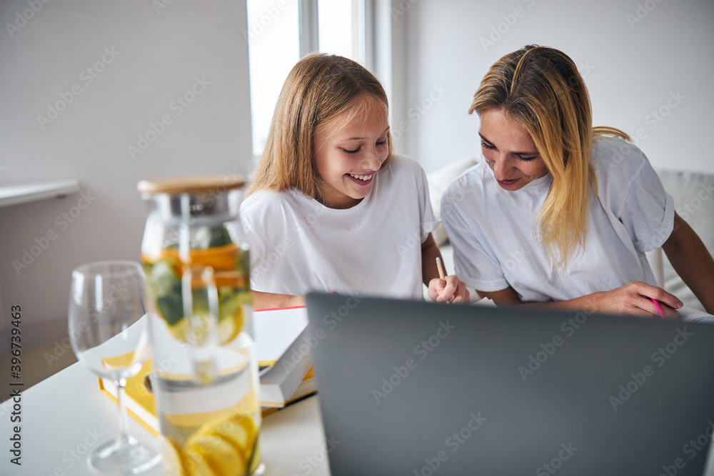 Daughter sharing something funny with her parent Daughter sharing something funny with her parent