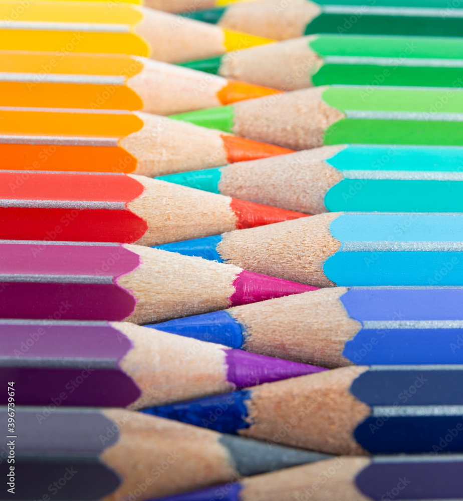 Colored pencils with tips arranged like a zipper. Macro still-file picture taken in studio with softbox. Colored pencils with tips arranged like a zipper. Macro still-file picture taken in studio with softbox.