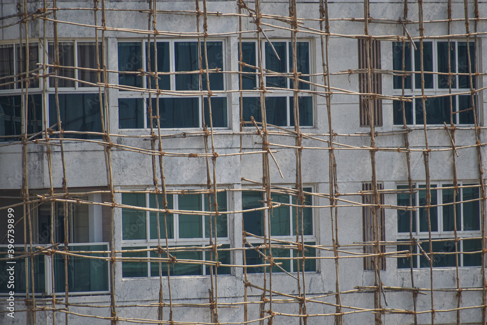 bamboo scaffolding on building ,construction site . Bamboo tied with jute ropes