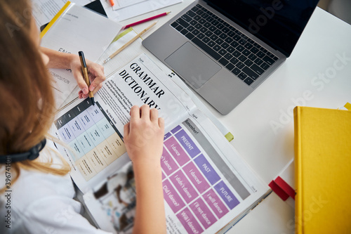 Teen marking the sentences with her pen