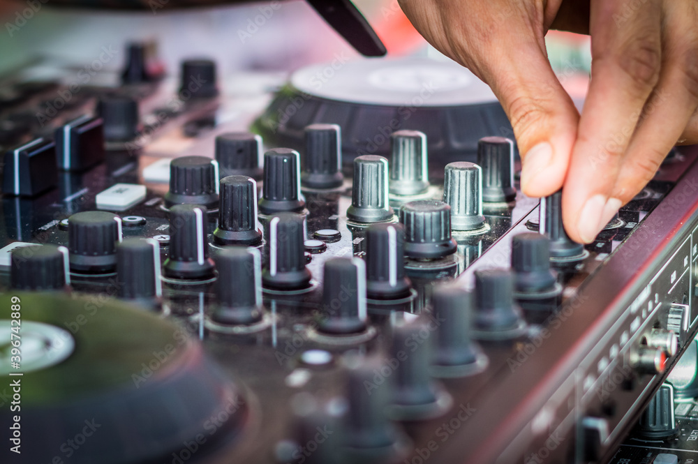DJ mixing music on console at the night club DJ mixing music on console at the night club